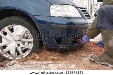 Tow rope being attached to the car towing eyelet
