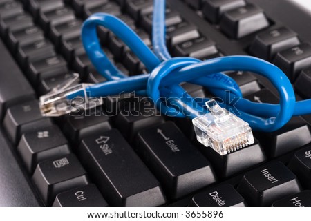 Network cable on black keyboard with not tied in the cable