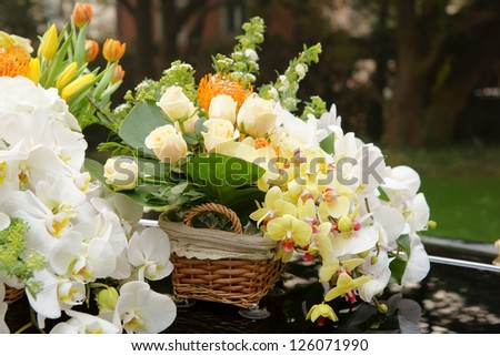 Wedding flowers sitting on the hood of a car./Wedding flowers/Wedding flowers