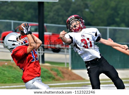 CUMMING, GA/USA - SEPTEMBER 8: Unidentified boy catching the pass at the goal line. Two teams of 7th grade boys September 8, 2012 in Cumming GA. The Wildcats  vs The Mustangs.