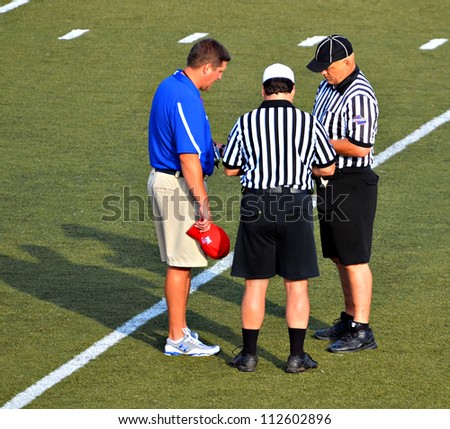 CUMMING, GA/USA - SEPTEMBER 8: Unidentified coach and officials before a football game of 7th grade boys September 8, 2012 in Cumming GA. The Wildcats  vs The Mustangs.
