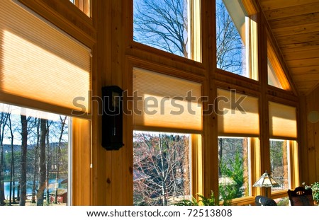 Large windows in a house showing the window treatments.