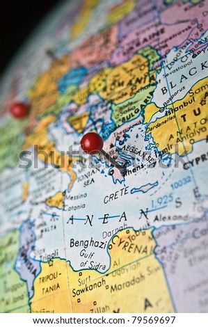 A travel or in-the-news concept, map of the world with a pin marking the area of Athens Greece.