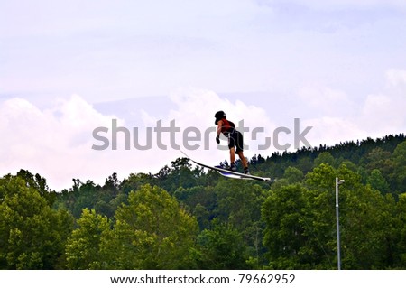 TALKING ROCK, GA/USA - JUNE 19: Unidentified man ski jumping during a  competition, June 19, 2011 in Talking Rock, GA at the  Whitestone Summer Starter Tournament.