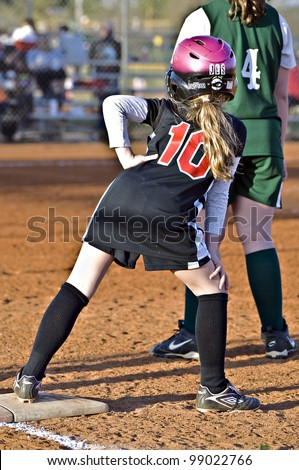 CUMMING, GA,USA - MARCH 3: Unidentified girl on base during a softball game of 9-10 year old girls, Coal Mountain Lady Bulldogs vs Central Green Vipers March 3, 2010, Forsyth County, Cumming GA.
