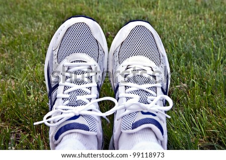 A pair of athletic shoes on a background of grass.