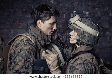 Portrait of loving each other U.S. Marines. Love in war. Girl nurse takes care of a U.S. marine.