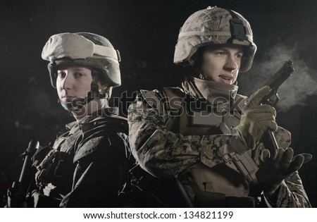 Two soldiers shoulder to shoulder, keeping defenses