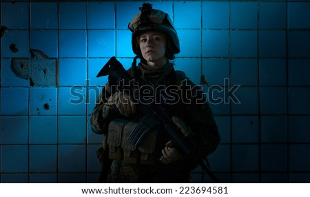 Dramatic portrait of a beautiful girl in uniform. Women in the military. U.S. Marines. Thoughts about the war. Young soldier.