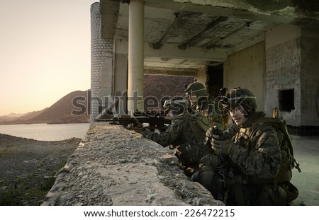 American soldiers guarding the building. Sniper attack the enemy from a secured position. Soldiers at Rest
