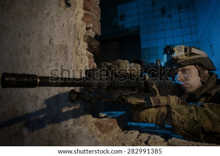 American soldier on the battlefield in an attack/defensive position.