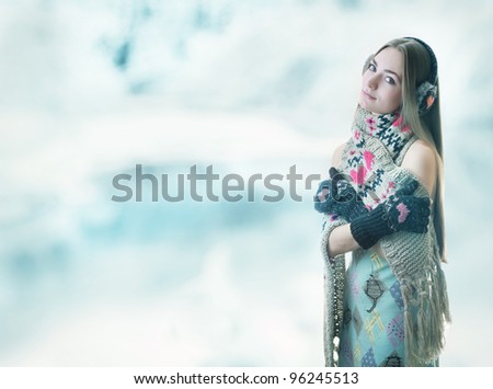 Beautiful girl on a cold background in home-made clothes