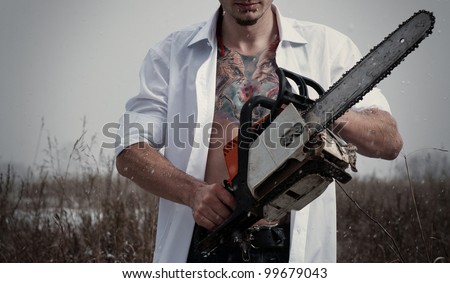 Portrait of Maniac man with a chainsaw
