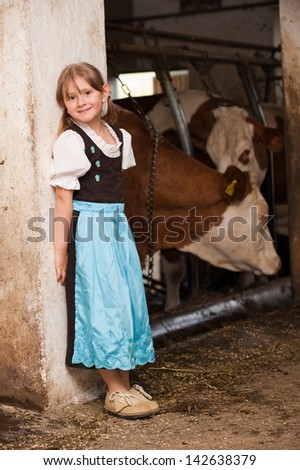 Little girl in a cow stable