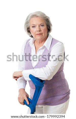 Senior woman with crutches isolated on white