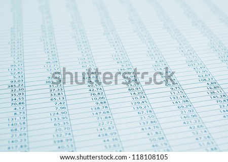 Business data report selective focus close up. Monthly stock stats spreadsheet. Blue toned.