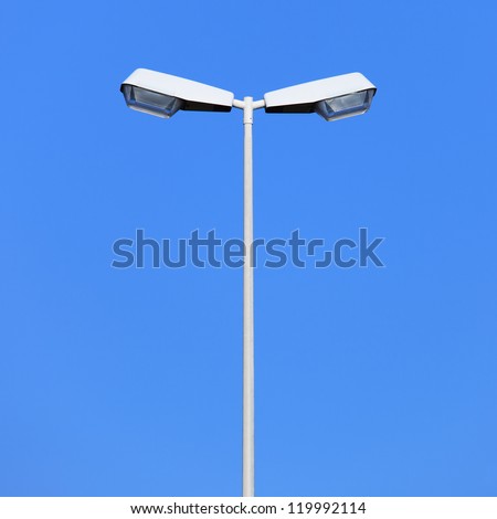 Double street light lamp post or lantern on a blue sky background