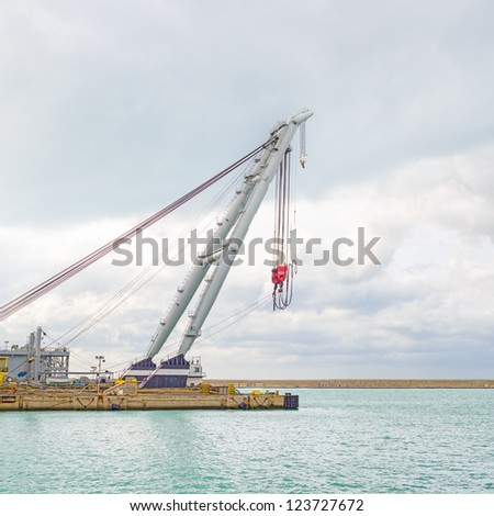 Quay Port Crane for container, cargo, ship or boat in industrial harbor.