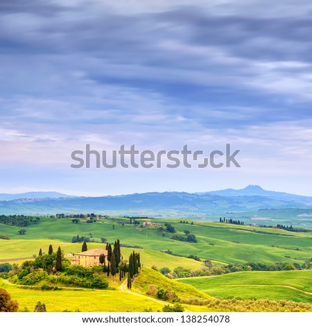Tuscany, farmland and cypress trees country landscape, green fields. San Quirico Orcia, Italy, Europe.