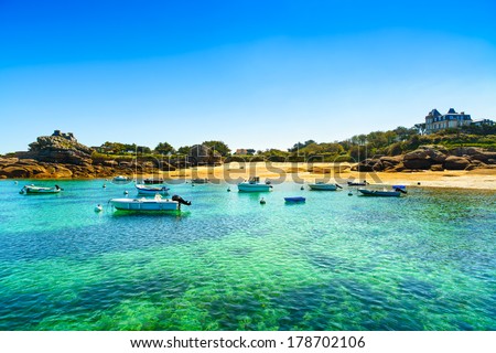Tregastel, boat in small beach bay in pink granite coast and atlantic ocean. Armor coast, Brittany, France. Europe.