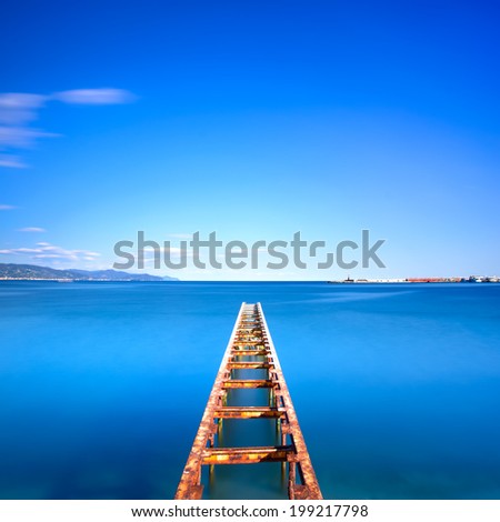 Wooden pier or jetty remains on a blue ocean sunset. Ligury, Italy. Long Exposure photography