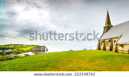 Etretat village, Church Notre Dame de la Garde chapel and Aval cliff. Normandy, France, Europe.
