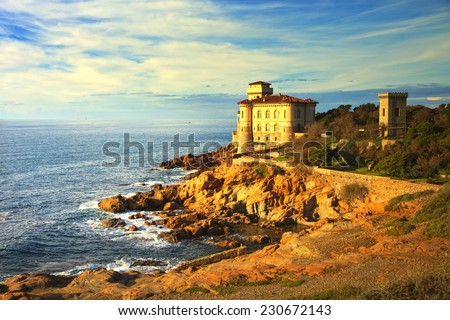 Boccale castle landmark on cliff rock and sea on warm sunset. Tuscany, Italy, Europe.