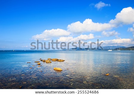 Rocks and yachts in a sea bay. Punta Ala beach, Maremma Tuscany, Italy
