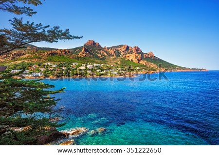 Esterel mediterranean red rocks coast, beach, tree and sea. French Riviera in Cote d Azur near Cannes Saint Raphael, Provence, France, Europe.