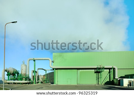 Geothermal energy. A steam coming out from a small green power plant.