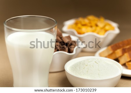 Mild, toast, cornflakes and milk powder on breakfast table