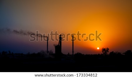 Sun set in industrial area  ,Industrial pollution, dangerous toxic smoke coming out from the chimney