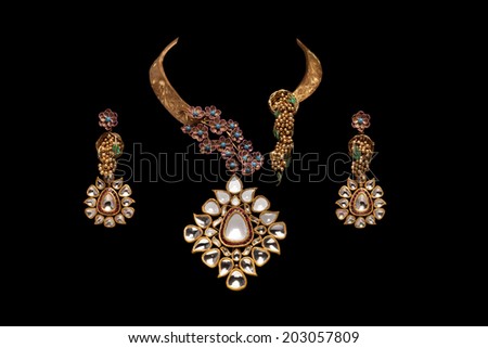 Close up of diamond necklace on black background with diamond earring