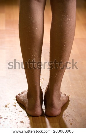 Wet legs of beautiful woman standing on wooden floor, coming from bathroom.