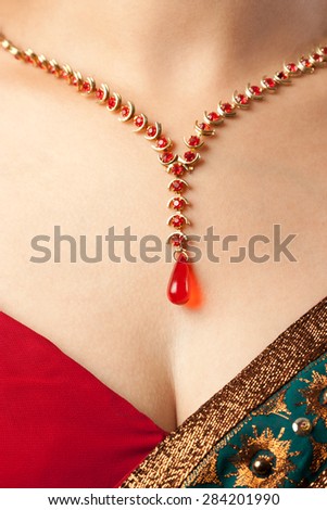 Close up of diamond necklace over female body skin