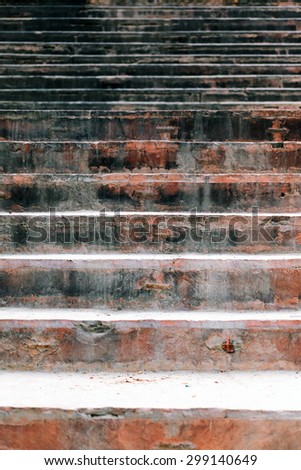Red old stone stairs in an old temple.