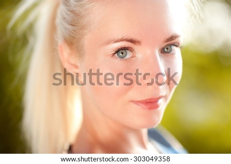 Smiling girl 20-24 year old posing outdoors. Looking at camera. Healthy lifestyle.