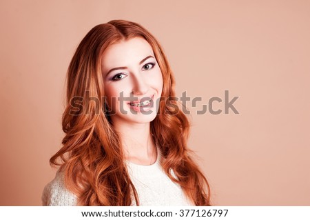 Smiling teenage girl 16-18 year old wearing braced over beige. Looking at camera. Health care.