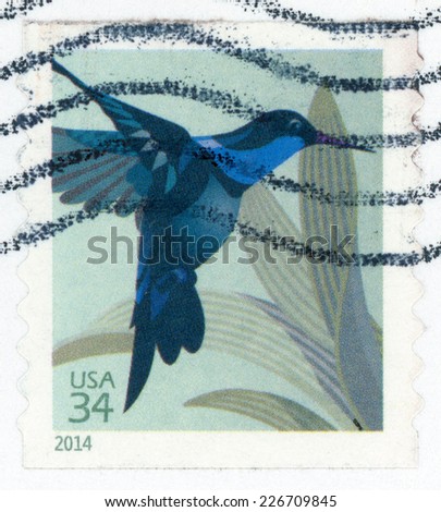 UNITED STATES OF AMERICA - CIRCA 2014: post stamp printed in USA (US) shows one of smallest birds in world Hummingbird flying near plant, Scott 4858 34c blue, circa 2014