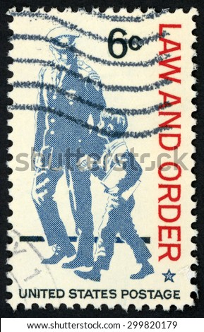 UNITED STATES - CIRCA 1968: stamp printed in USA shows policeman & small boy walking & holding hands; police as protector & friend; respect for law & order; Scott 1343 A765 6c blue red; circa 1968