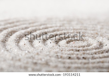 Japanese zen garden meditation for concentration and relaxation. Sand circles in spiral for harmony and balance in pure simplicity. Macro lens shot.
