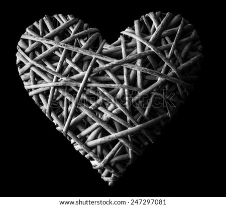 (withe, withy, osier, sallow, vine) braided on a frame in the form of hearts isolated on a black background, BW photo