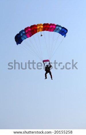 Ð aratrooper, parachute jumper in jump, isolate on blue sky.