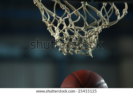 Action shot of basketball going through basketball hoop