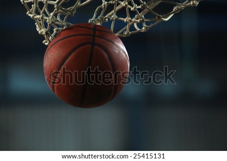 Action shot of basketball going through basketball hoop