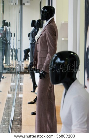 Mannequins and reflections in the window of a fashionable women\'s clothing store