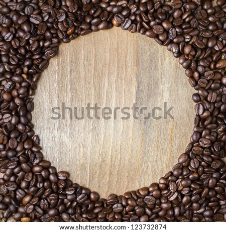 Round wooden frame from coffee beans. Space for text