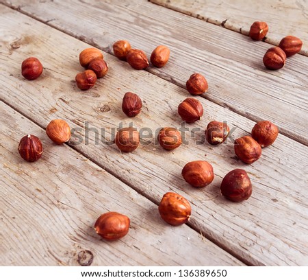 Many nuts scattered on wood background texture. Top view