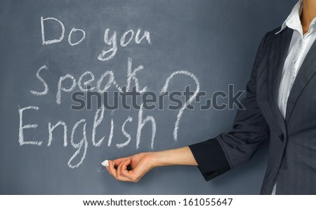 Unrecognizable Teacher Points To The Phrase: Do You Speak English?
