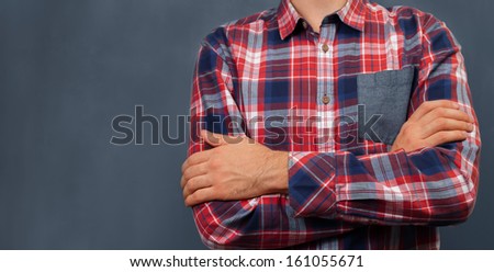 Unrecognizable man in shirt standing near the blackboard, space for text
